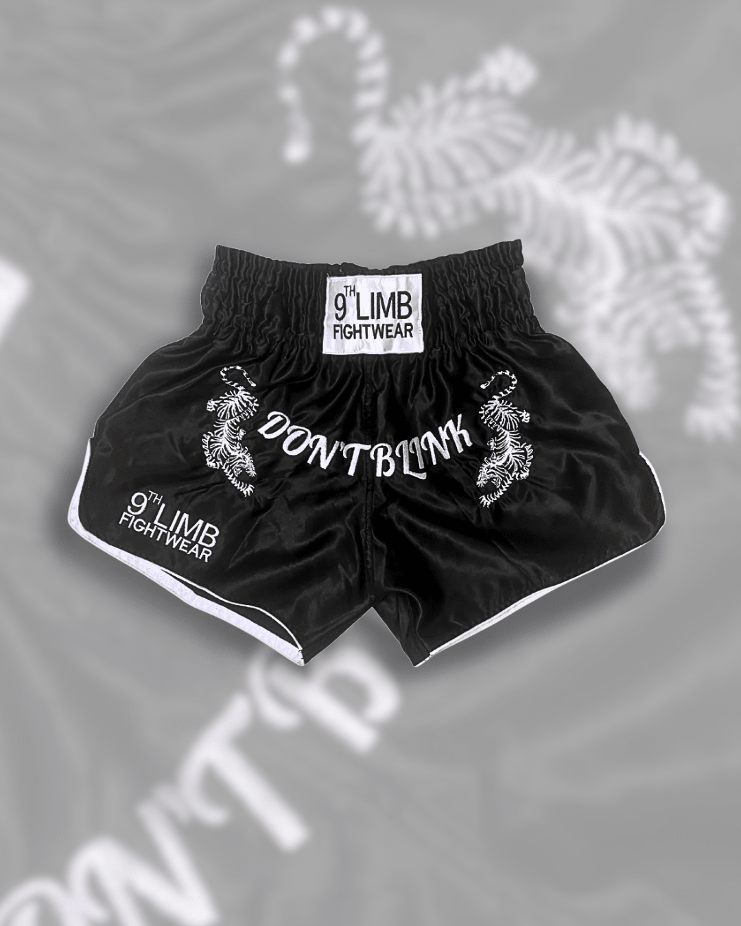 Black 9th Limb “Don’t Blink” Muay Thai Shorts – Black Satin Fightwear - 9thLimbHQ